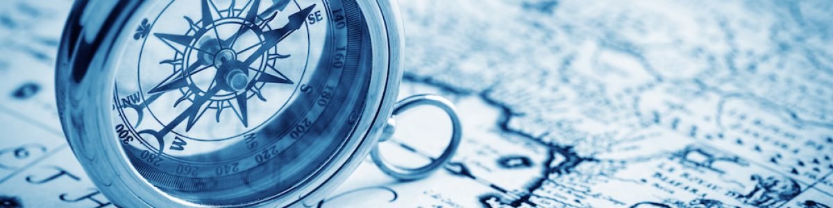 antique compass on vintage map background